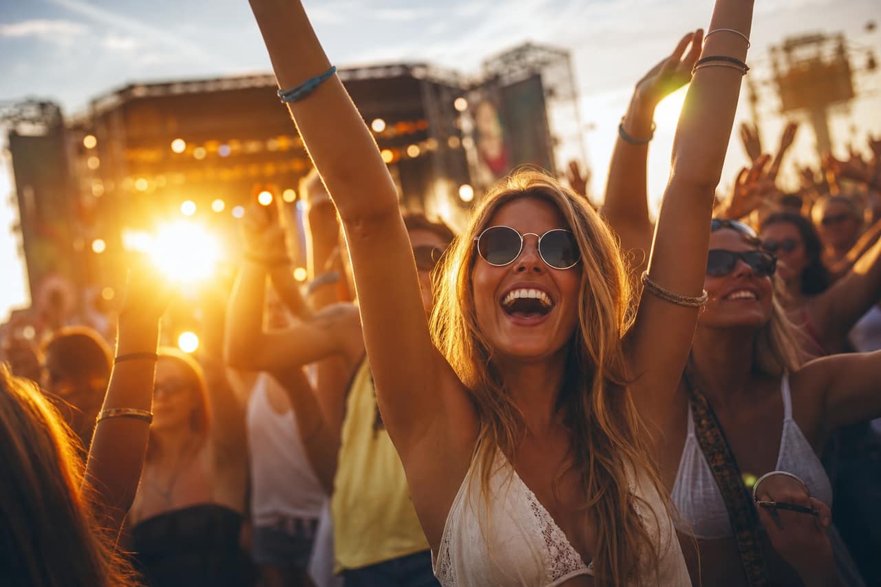 A festival crowd at an outdoor stage
